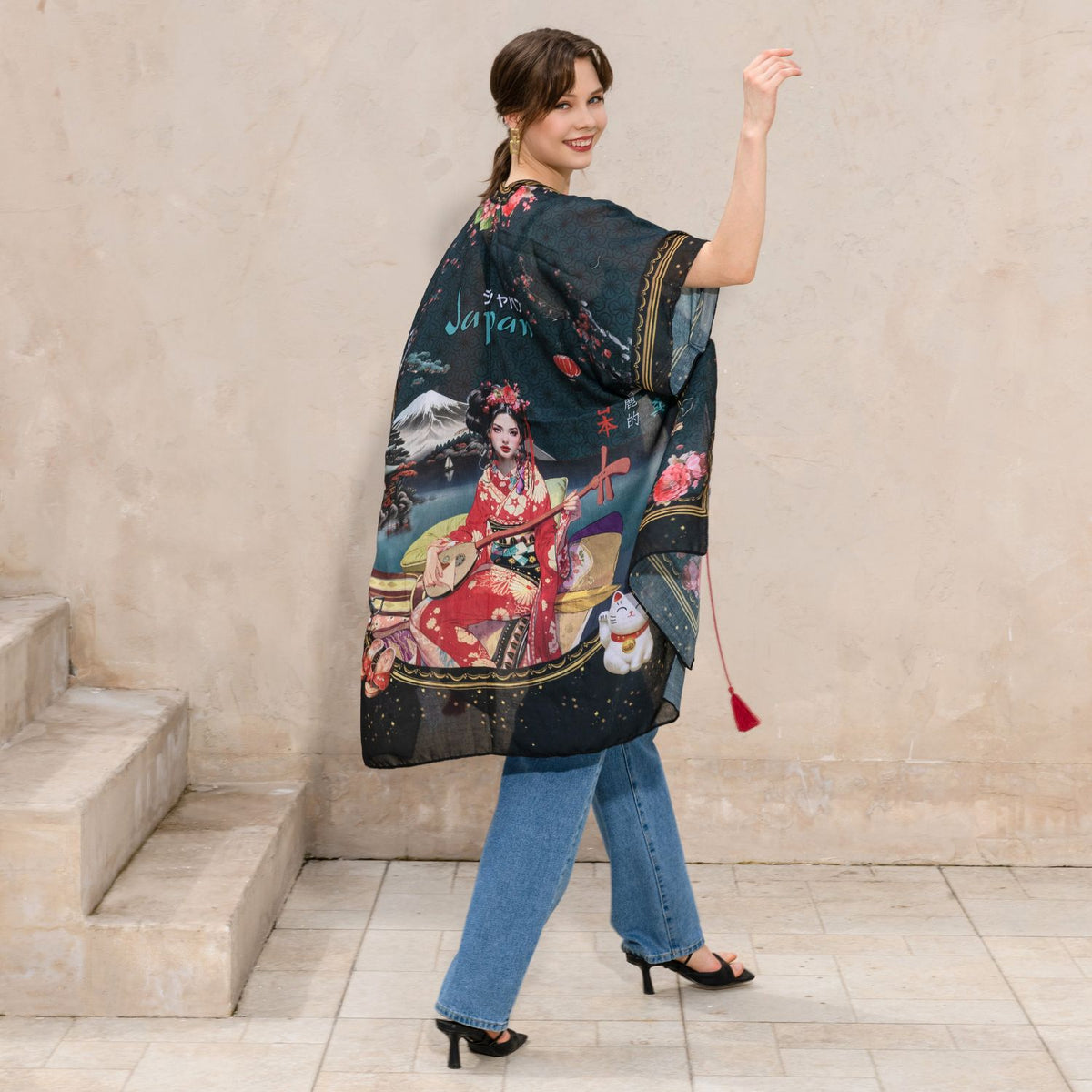 Woman in black top, blue jeans with black heels smiling away wearing our Nicole Lee Kimono Akiko la Belleza design.
