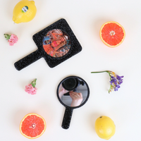 OUR RECTANGLE HAND MIRROR AND OUR ROUND MIRROR IN OUR NICOLE LEE MARTHA TRAVELS ITALY DESIGN SET ON  A WHITE BACKGROUND WITH ORANGES, LEMONS AND FLOWERS.