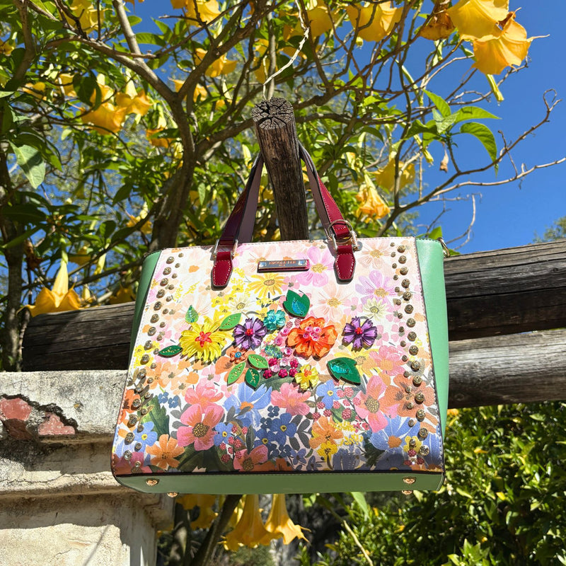 OUR NICOLE LEE DREAMS BLOSSOM TOTE SET IN A NATURE BACKGROUND.