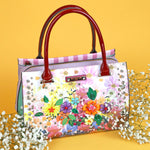 OUR NICOLE LEE SATCHEL BAG  IN DREAMS BLOSSOM DESIGN SET IN A YELLOW BACKGROUND AND WHITE LITTLE FROWERS.