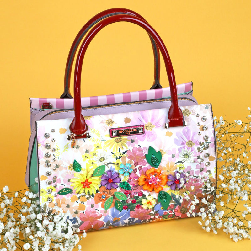 OUR NICOLE LEE SATCHEL BAG  IN DREAMS BLOSSOM DESIGN SET IN A YELLOW BACKGROUND AND WHITE LITTLE FROWERS.