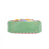 THE BOTTOM IS MADE OF VEGAN LEATHER IN A MINT GREEN COLOR.