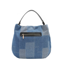 Back view of our denim hobo Bag in our Nicole Lee Bosque de Amor design with black handles and Cotton denim exterior with faux vegan leather accents.