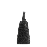 Side silhouette of Juni handbag crafted in braided vegan leather in classic, timeless black with a top handle (5" drop). Slouchy, relaxed silhouette offers a chic and laid-back yet refined look.