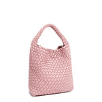 Front angle of Juni handbag crafted in braided vegan leather in pastel, dusty pink with a top handle (5" drop) and open slip compartment secured with a magnetic snap closure. Slouchy, relaxed silhouette offers a chic and laid-back yet refined look.