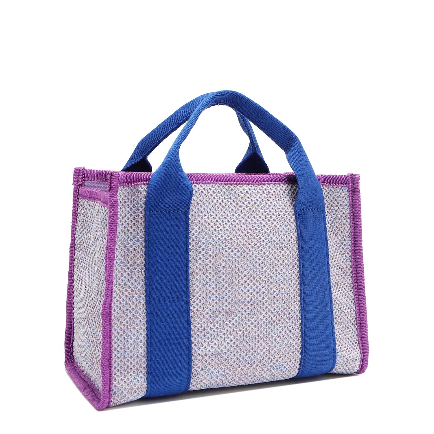 Back angle view of the Nodu Nadu small canvas Marley tote Bag in lavender. Accented with bold electric blue straps and a gorgeous purple trim, this canvas features a subtle metallic shimmer that hits the light whenever you walk for a head-turning detail. 
