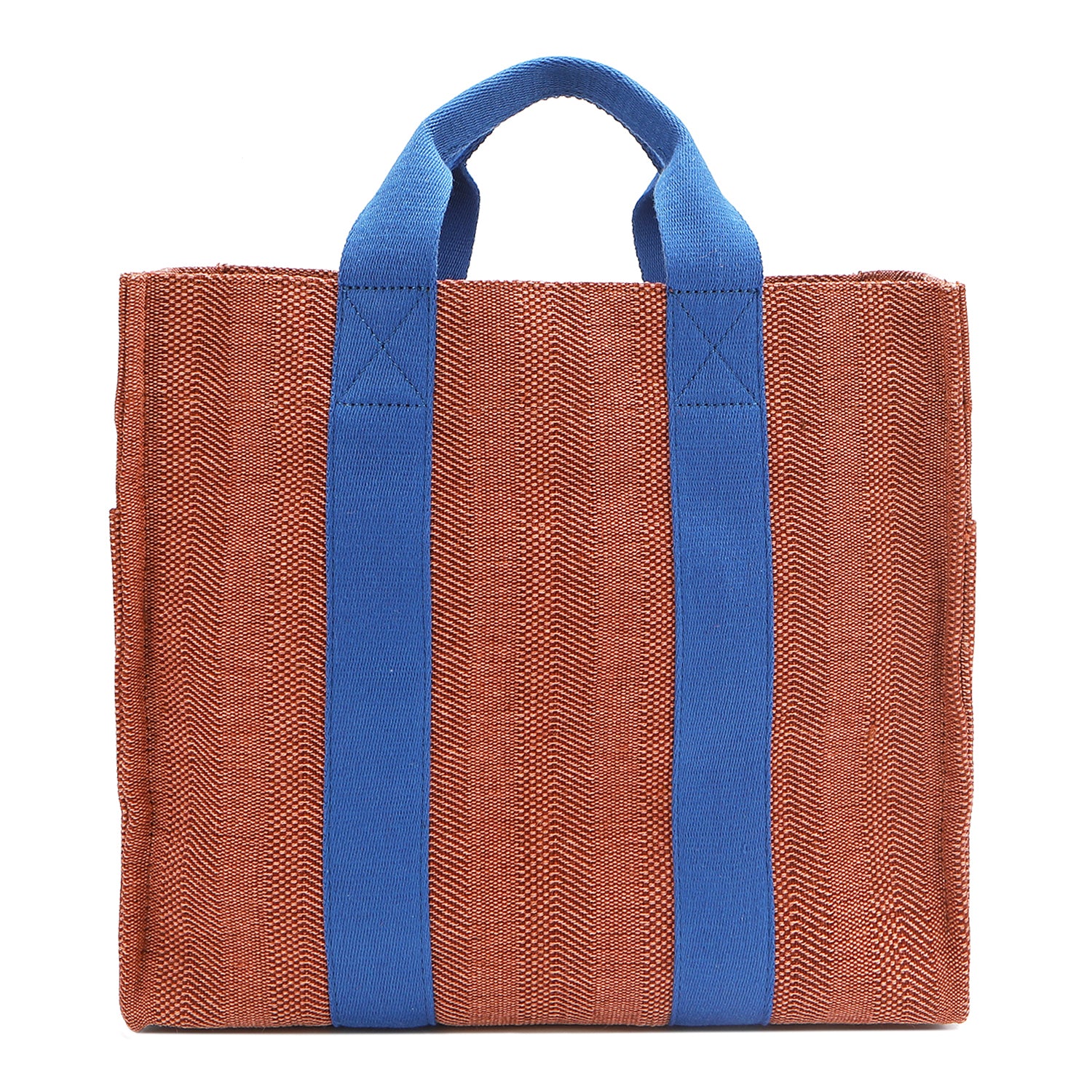 Back of the Nodu Nadu Sawyer Bag in Orange. Orange/sienna brown-colored canvas accented with bold electric blue straps for a pop of trendy color and vibrance. Rectangular silhouette provides a sense of classic timelessness so you can dress up or dress down this everyday style. 