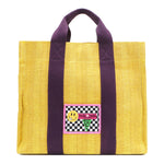 Your must-have carryall for school, weekends, and everything in between! Designed with a soft, relaxed silhouette, the Nodu Nadu Sawyer in Yellow offers plenty of space to keep notebooks and loose essentials effortlessly organized—so you're always ready to grab and go! Sunny yellow canvas paired with eggplant purple strap accents. 