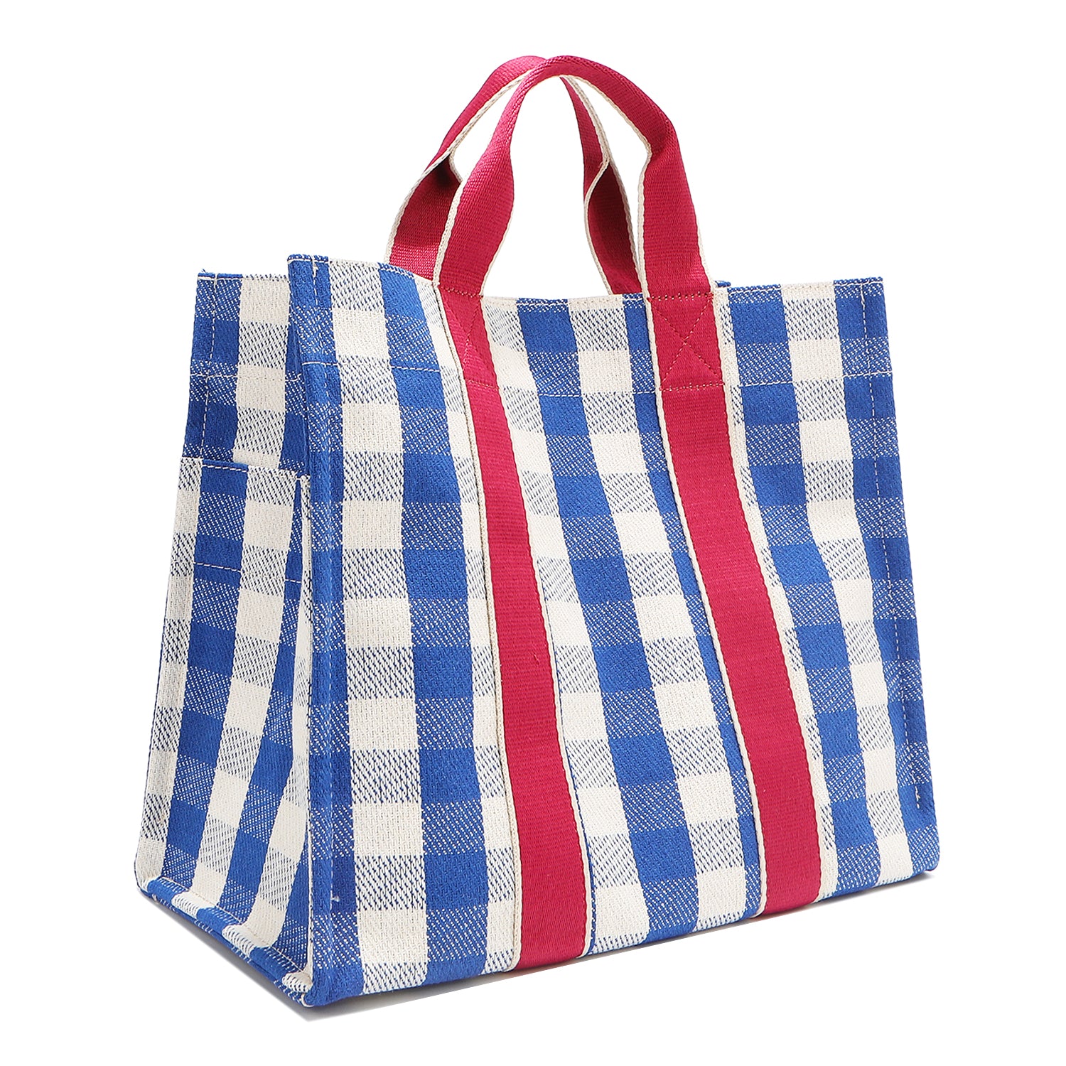 Back corner angle of the Nodu Nadu Canvas Bag in Blue – featuring wide blue and white gingham print and vertical pink webbing. Side view shows the deep open slip pockets that you can store most-used items like your phone, keys, and makeup, close at hand! 