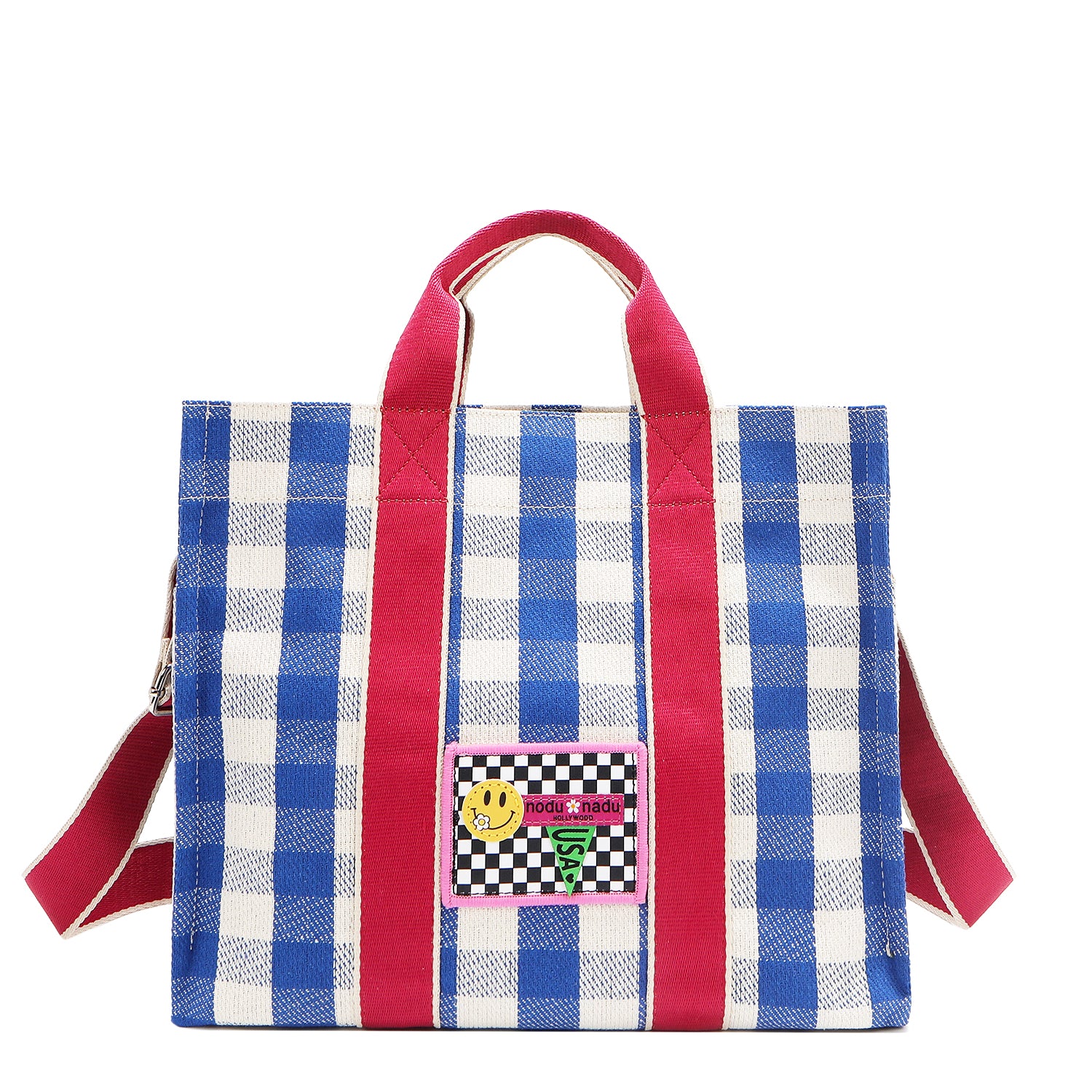 Your new go-to bag with a gingham twist! The Nodu Nadu Blair Bag in Blue brings a perfect mix of timeless charm and everyday durability, featuring a structured yet roomy silhouette, handy side pockets, and a back slip compartment to keep your essentials effortlessly organized. Pictured with the optional, adjustable shoulder strap attached for varied carrying options and versatility when wearing. 