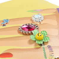 OUR NAIL POLISH HOBO BAG FRONT IS EMBELLISHED WITH RESIN FLOWERS, GEMS, AND JEWELS