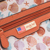 Close-up of a bag with our visible Nicole Lee brand label and shell pattern