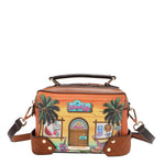 Our Sun and Sand Crossbody bag with a tropical design featuring palm trees and a beach scene set on a white background.
