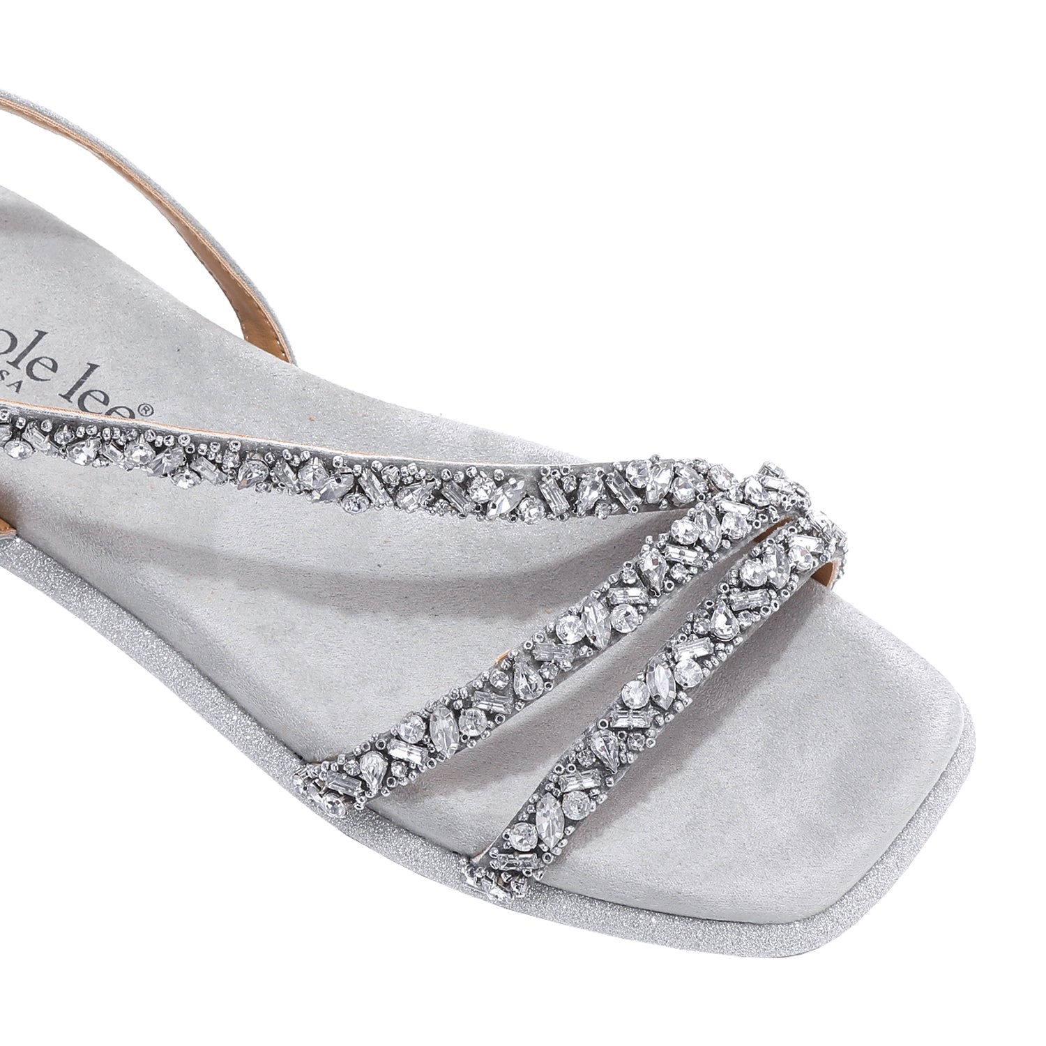 A CLOSER LOOK ON OUR DANI SANDAL. RHINESTONE ENCRUSTED CRISSCROSS STRAPS AND A MODERN SQUARE TOE.