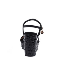 The platform  wedge is adorned with black rhinestones and  braid detailing.