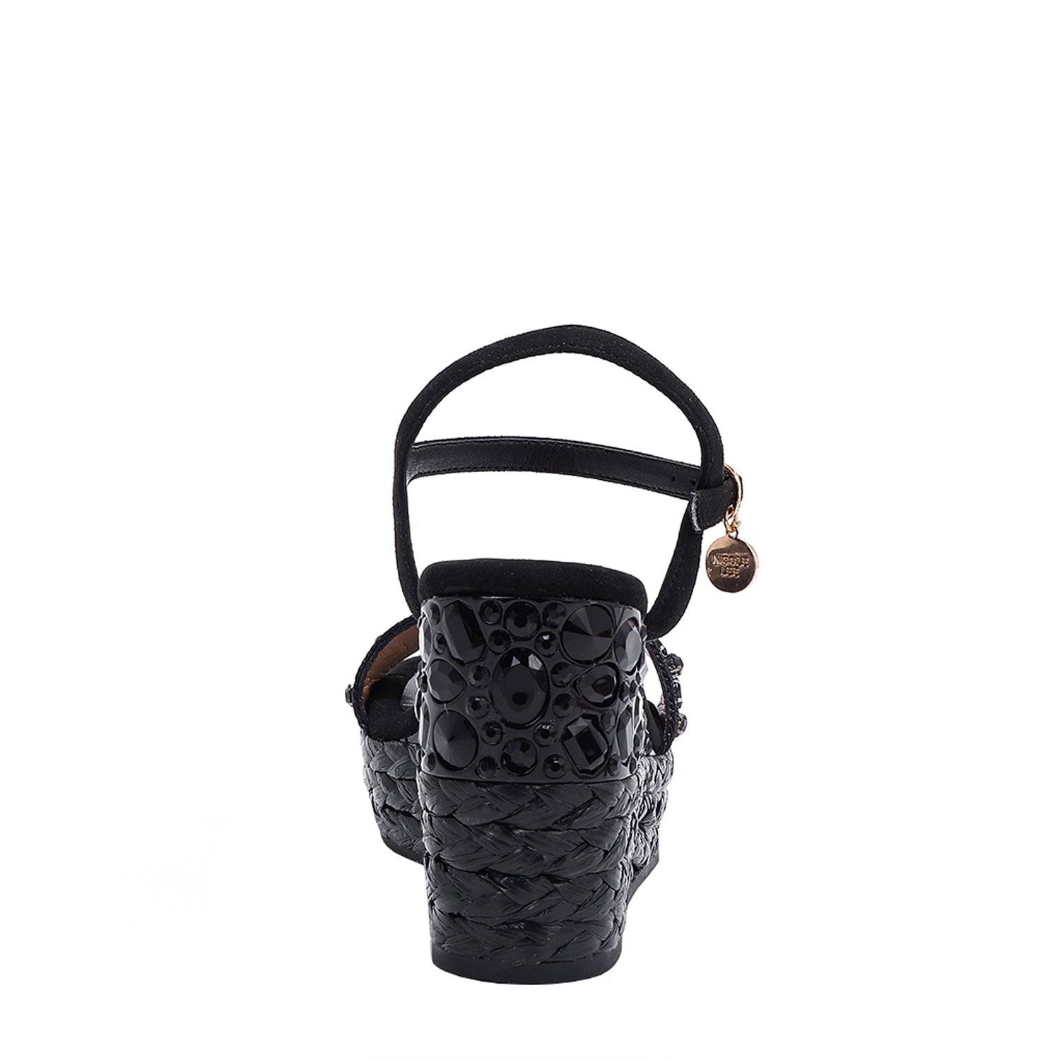 The platform  wedge is adorned with black rhinestones and  braid detailing.