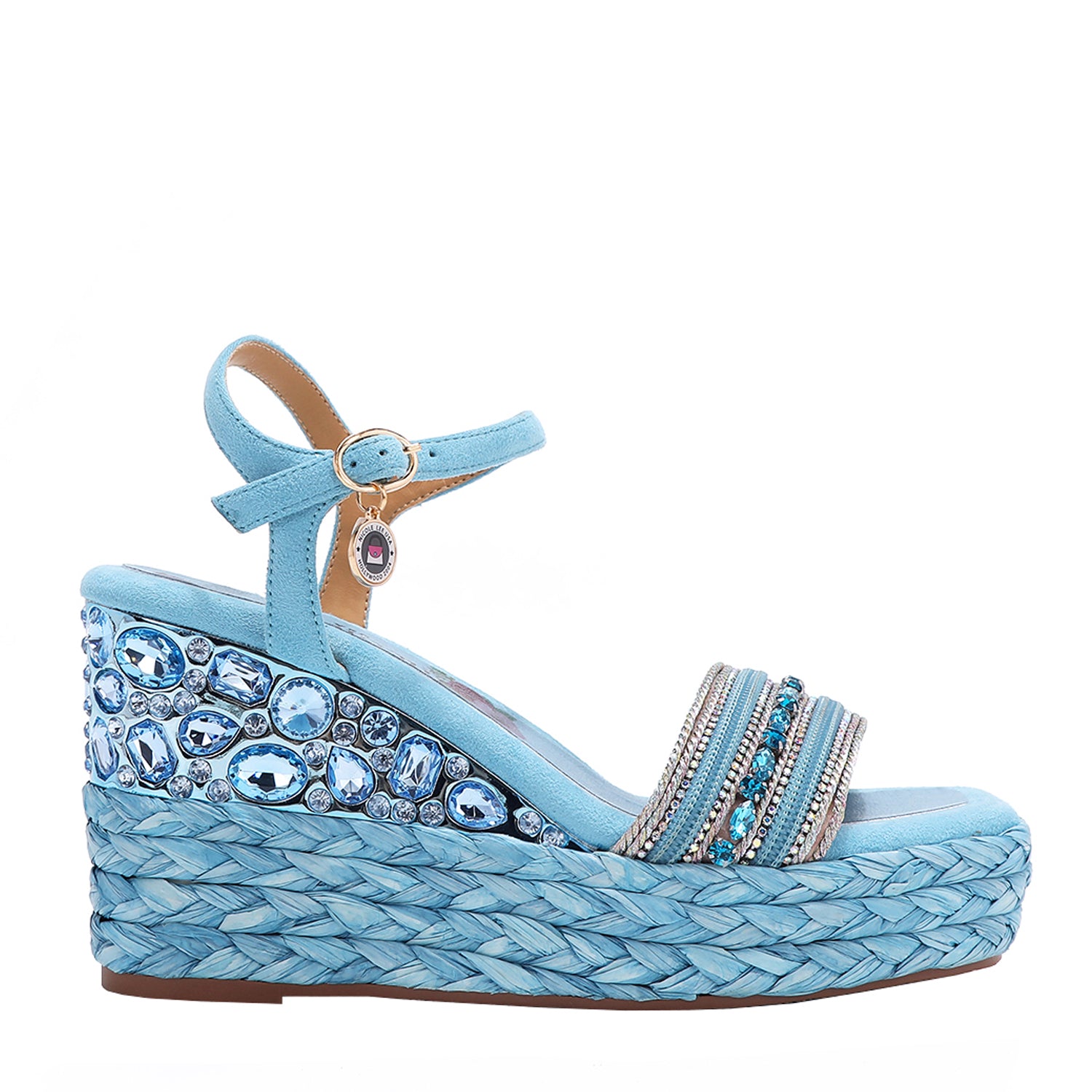 Kali Espadrille Wedge sandal in blue.  Fitted with 1 adjustable buckle. The buckle has a small Nicole Lee Charm.The wedge is adorned with rhinestones and  braid detailing.