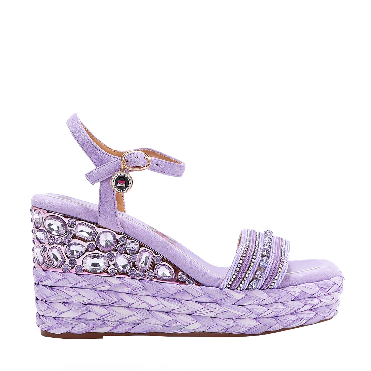 Kali Espadrille Wedge sandal in Purple.  Fitted with 1 adjustable buckle. The buckle has a small Nicole Lee Charm.The wedge is adorned with rhinestones and  braid detailing.