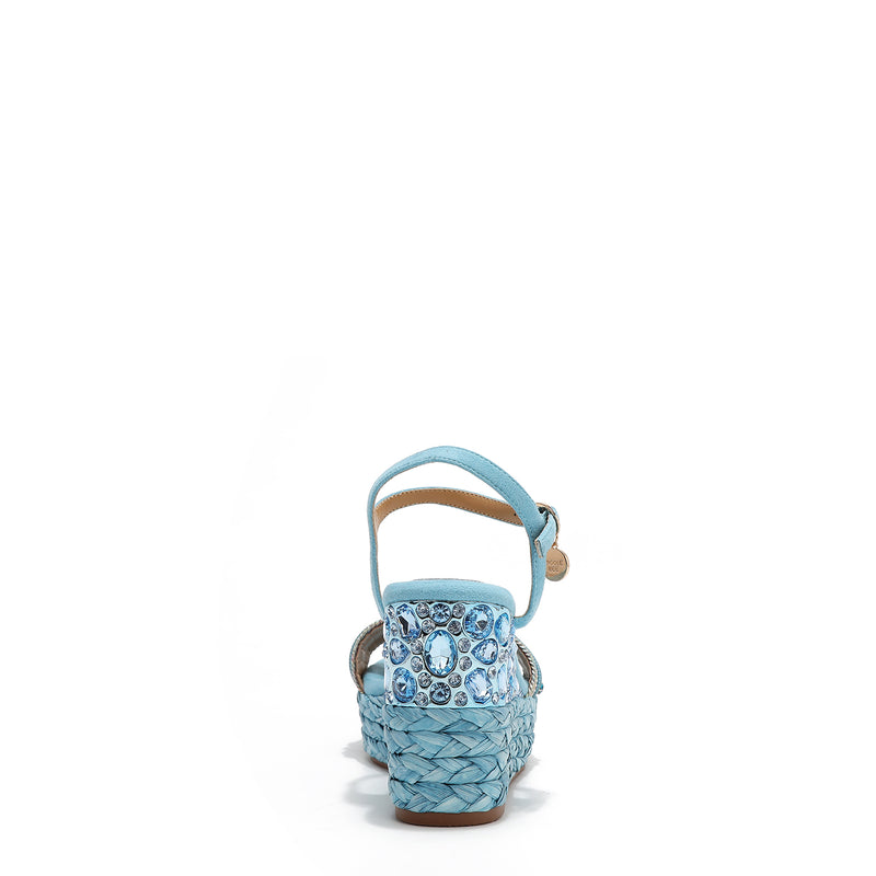 The platform wedge is adorned with blue rhinestones and  braid detailing.