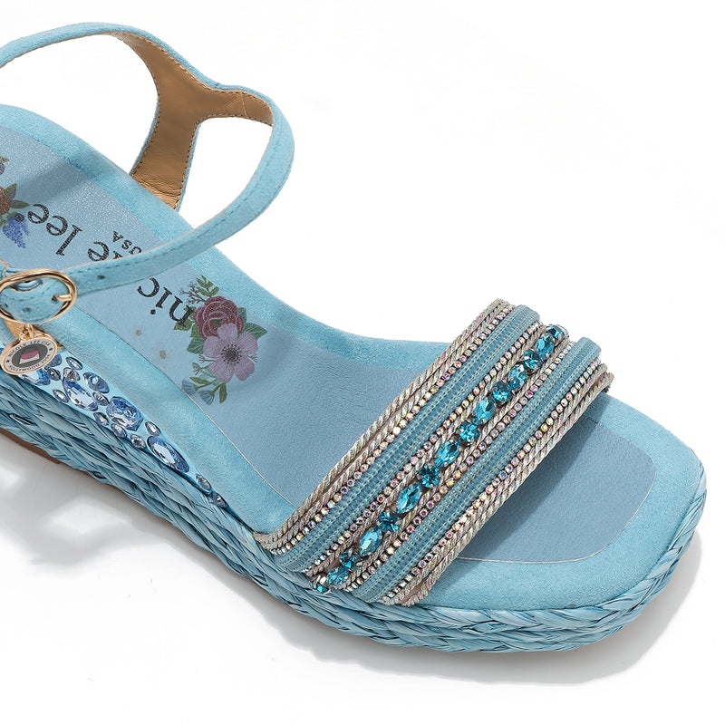 Kali Espadrille Wedge sandal in blue.  Fitted with 1 adjustable buckle. .The insole is gold with the Nicole Lee logo. Top strap is embellished with rhinestones.