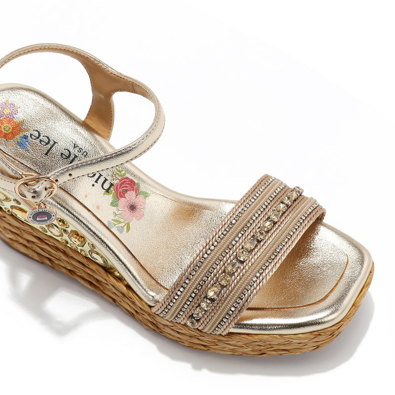 Kali Espadrille Wedge sandal in gold.  Fitted with 1 adjustable buckle. .The insole is gold with the Nicole Lee logo. Top strap is embellished with rhinestones.