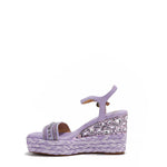 Kali Espadrille Wedge sandal in Purple.  Fitted with 1 adjustable buckle. The buckle has a small Nicole Lee Charm. The wedge is adorned with rhinestones and  braid detailing.