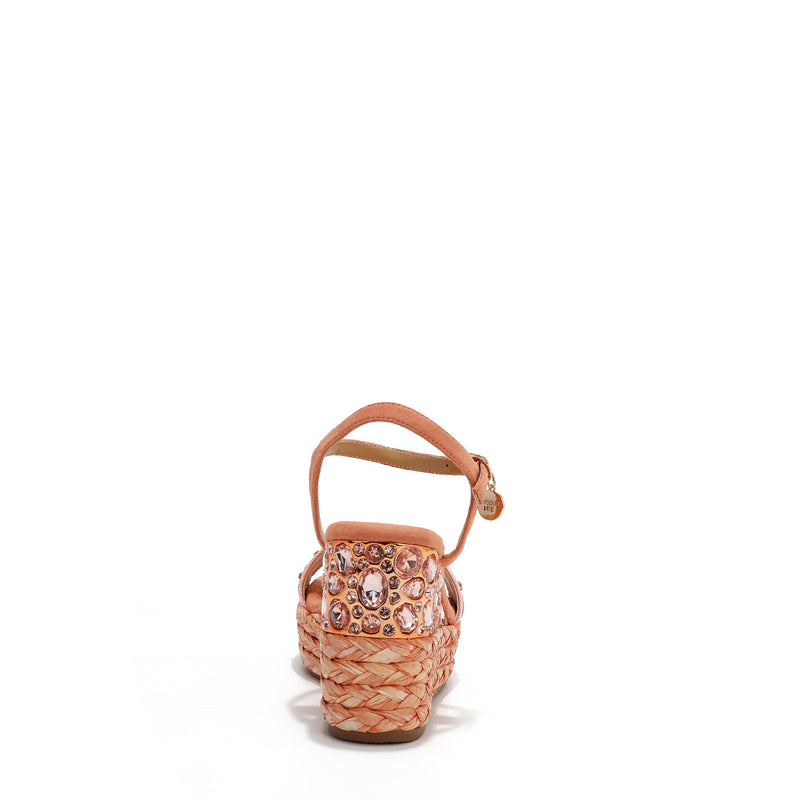 The platform wedge is adorned with pink rhinestones and  braid detailing.
