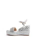 Kali Espadrille Wedge sandal in Silver.  Fitted with 1 adjustable buckle. The buckle has a small Nicole Lee Charm.The wedge is adorned with rhinestones and  braid detailing.