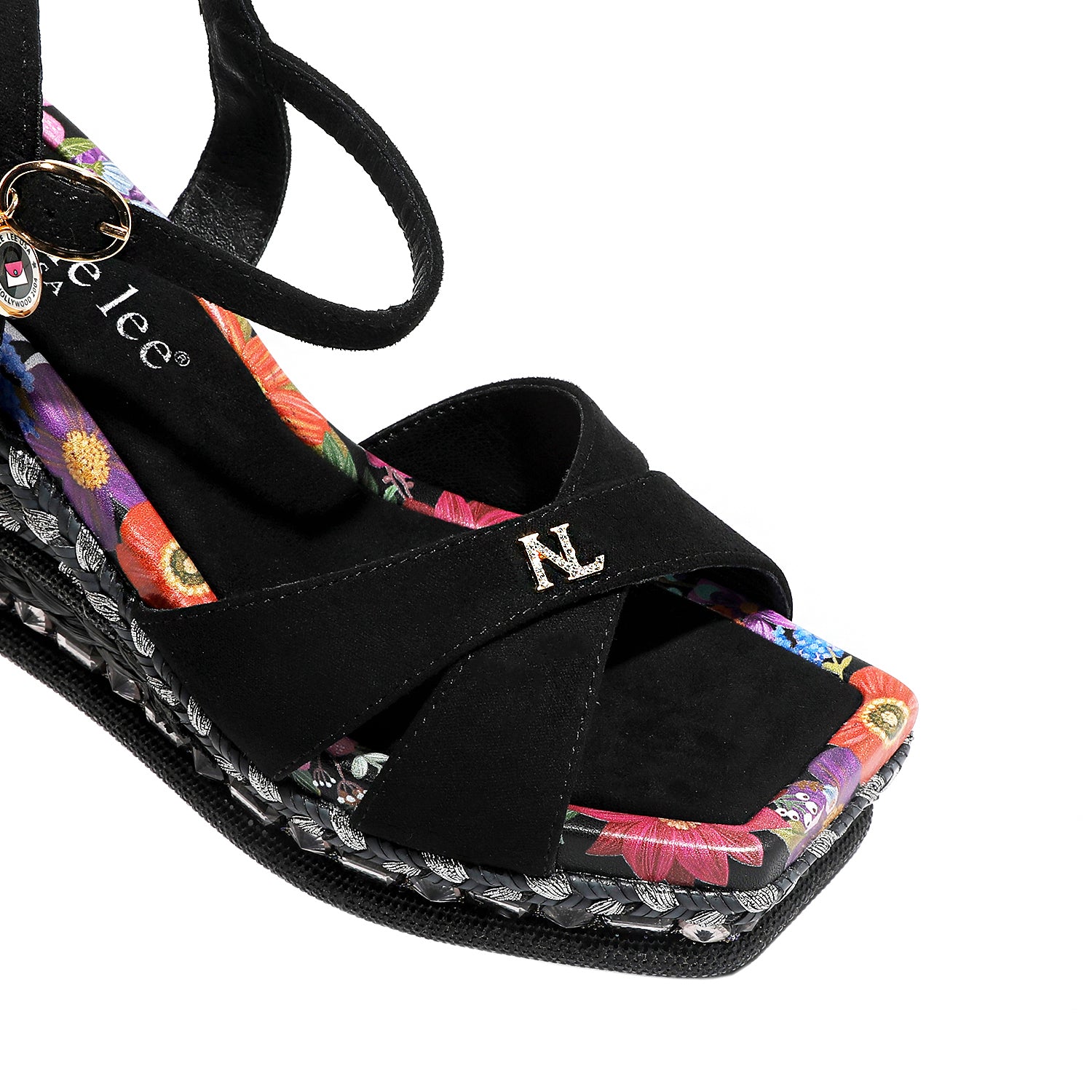 BONNIE ESPADRILLE WEDGE SANDAL THE CRISSCROSS STRAPS WITH THE NL INITIALS IN THE MIDDLE. THE BLACK INSOLE WITH FLORAL PRINT ON THE EDGES.