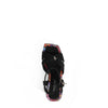 THE SANDAL FROM A VIEW FROM ABOVE. THE CRISSCROSS STRAPS WITH THE NL INITIALS IN THE MIDDLE. THE BLACK INSOLE WITH FLORAL PRINT ON THE EDGES.