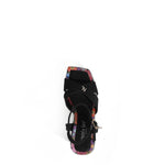 THE SANDAL FROM A VIEW FROM ABOVE. THE CRISSCROSS STRAPS WITH THE NL INITIALS IN THE MIDDLE. THE BLACK INSOLE WITH FLORAL PRINT ON THE EDGES.