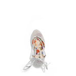 MAYA WRAP ESPADRILLE WEDGE SANDAL FROM A VIEW FROM ABOVE. FEATURES RHINESTONE MESH TOE CAP. TWO STRAPS THAT ARE TIED IN A BOW SHAPE.  THE INSOLE HAS A FLORAL PRINT.