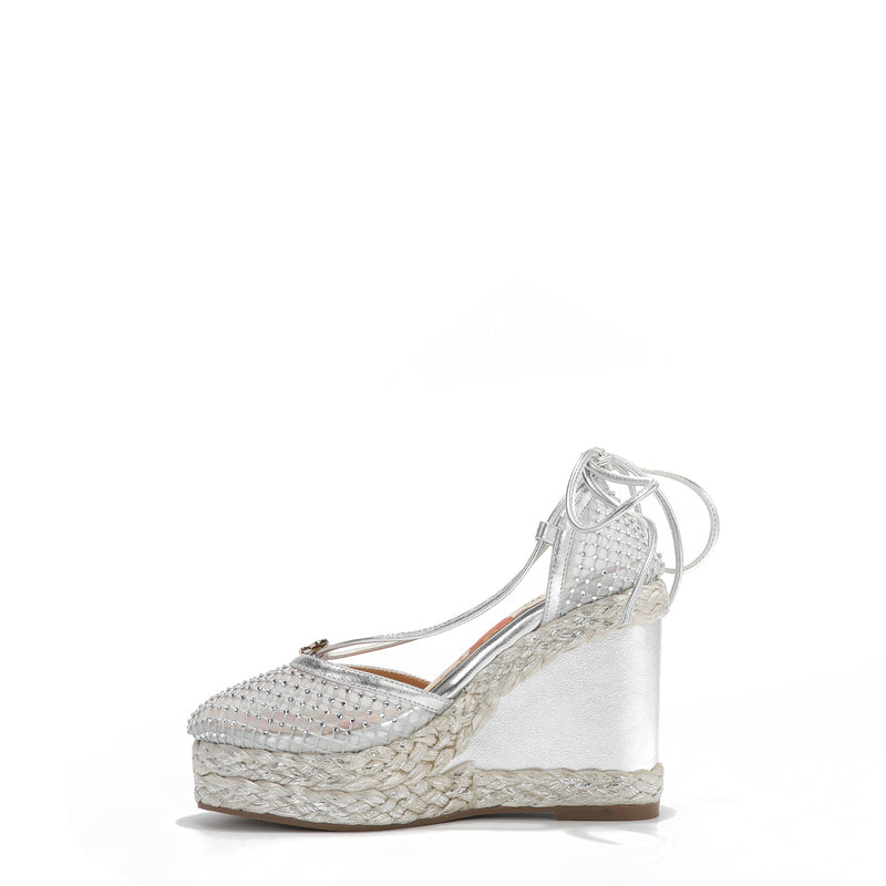 MAYA WRAP ESPADRILLE WEDGE SANDAL IN COLOR SILVER. RHINESTONE MESH TOE CAP AND A BRAIDED TRIM PLATFORM. IT HAS TWO STRAPS WHERE YOU CAN TIE IT ON THE BACK OF THE ANKLE.