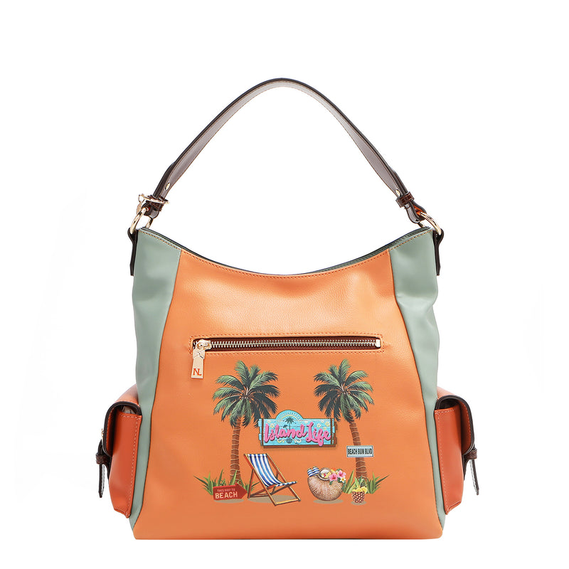 Our Sun and sand Hobo bag with a tropical design featuring palm trees and chair.