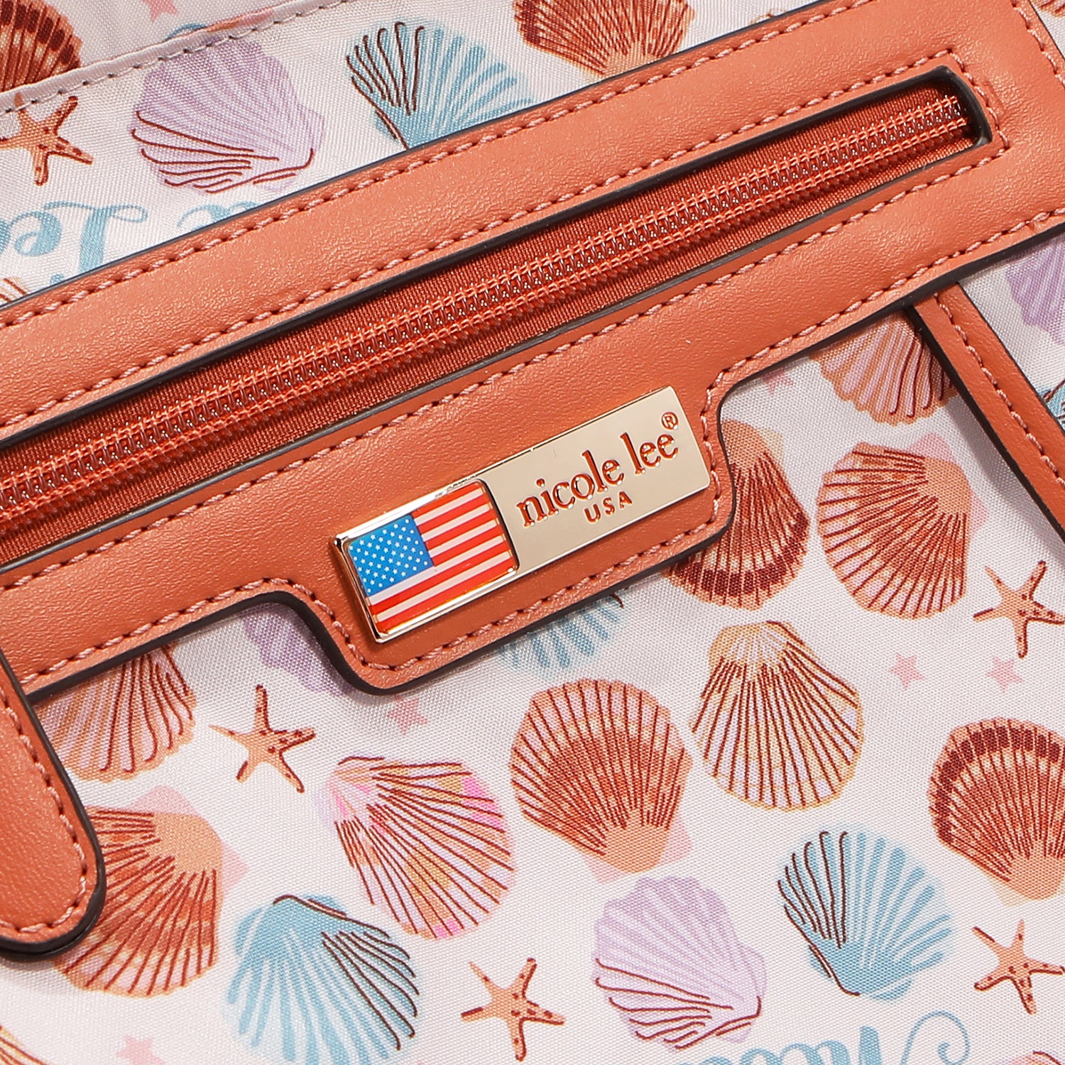Close-up of a 'nicole lee' logo on a shell-patterned background
