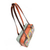 Our Sun and Sand Shoulder Handbag with a tropical design of a beach house scene set on a white background